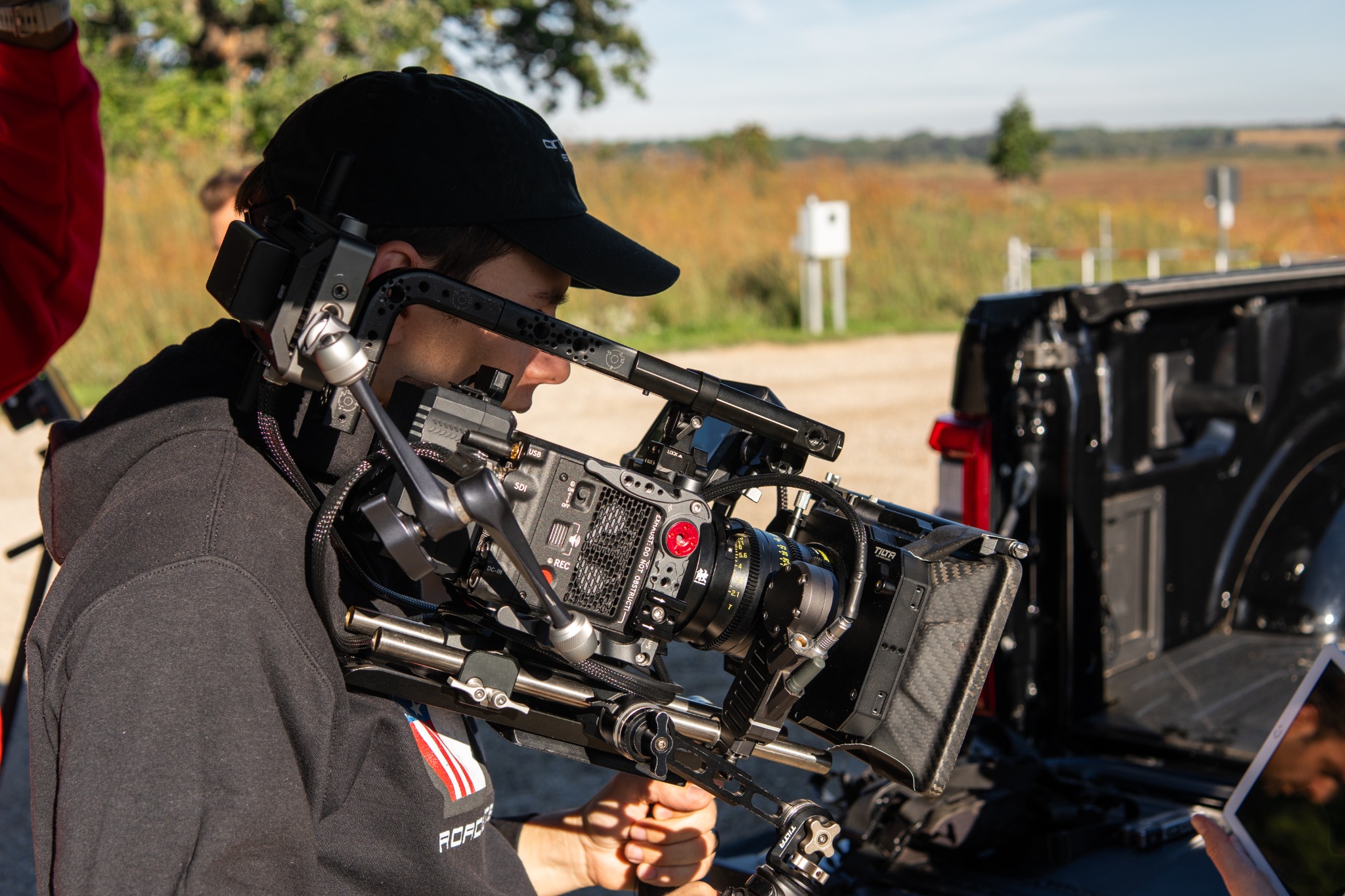 Camera operator carrying a cinema rig on location