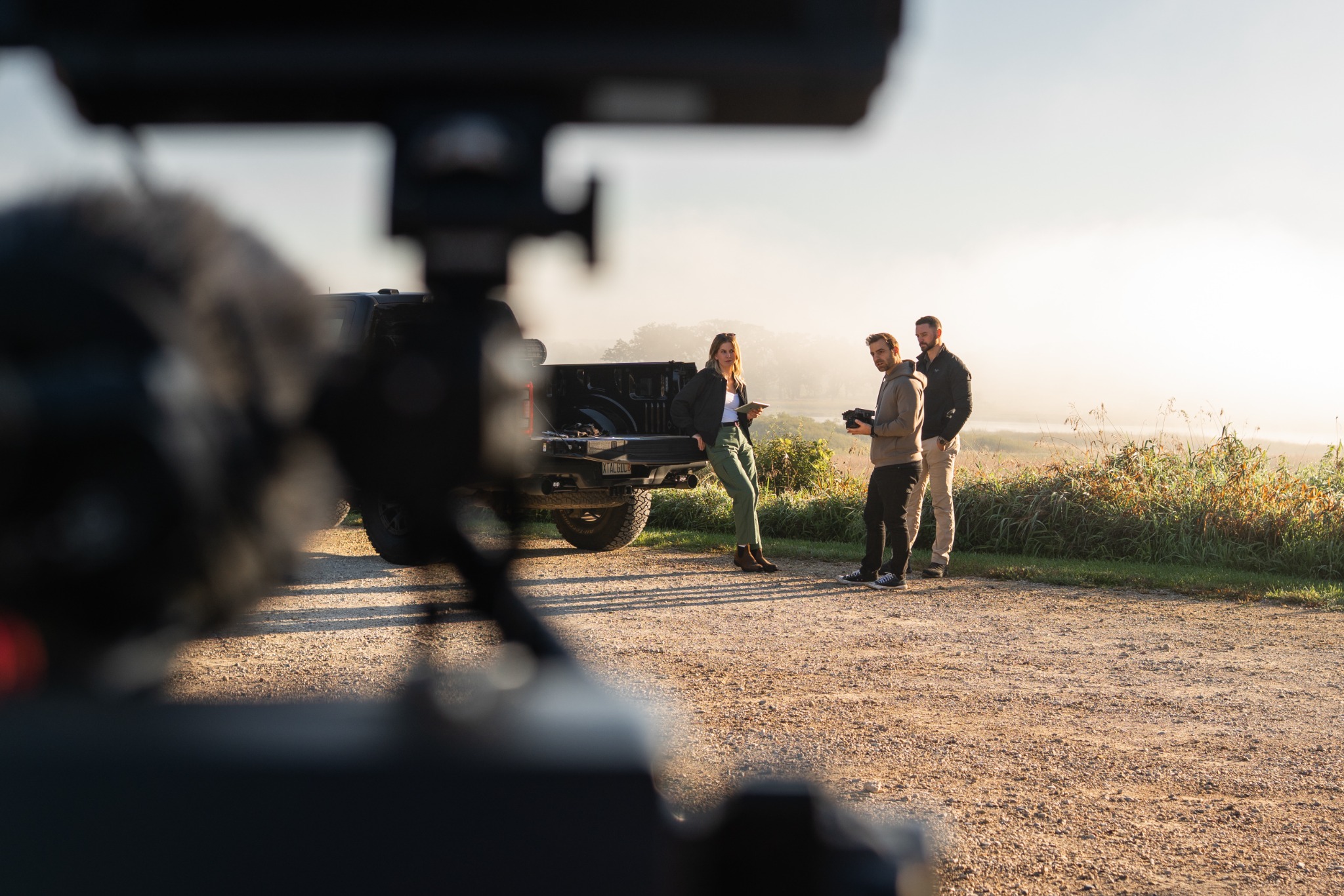 Crew filming a scene in an open field