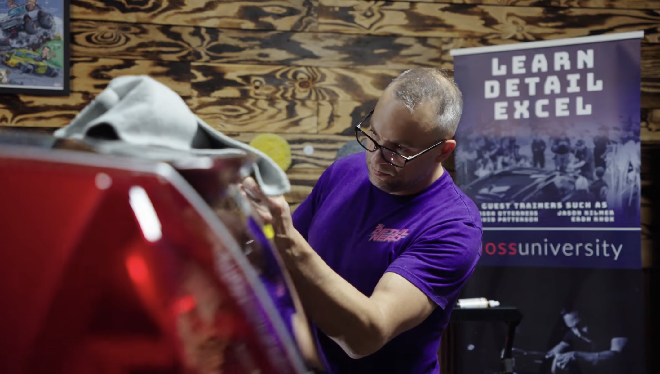 A Gloss University instructor working on a car during detailing training